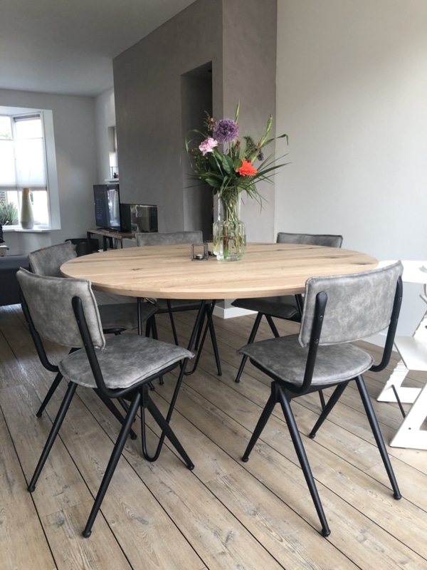 round oak table with a rejuvenated edge with black base