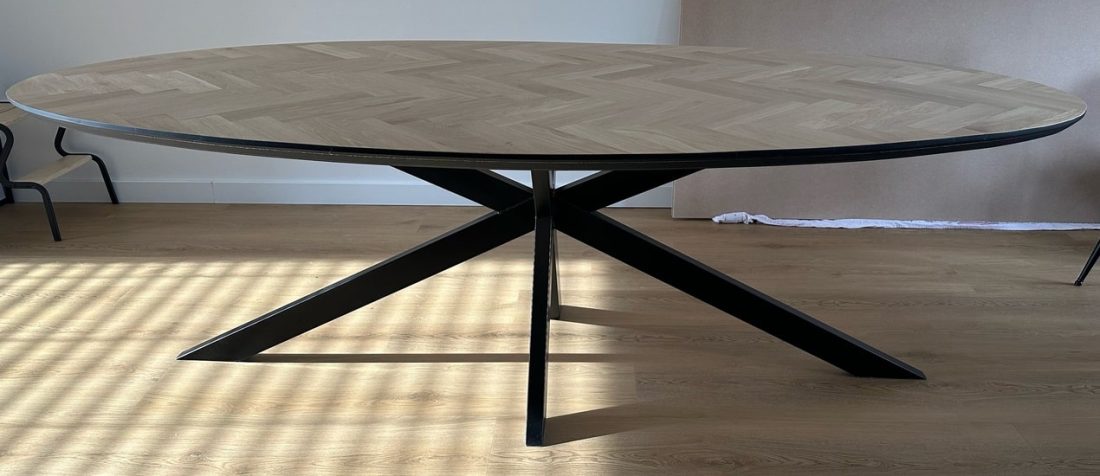 Milin oval herringbone oak table 240 x 120 x 4cm with tapered black edge 1 x 45 degrees with matrix base 5 x 5cm with black coating