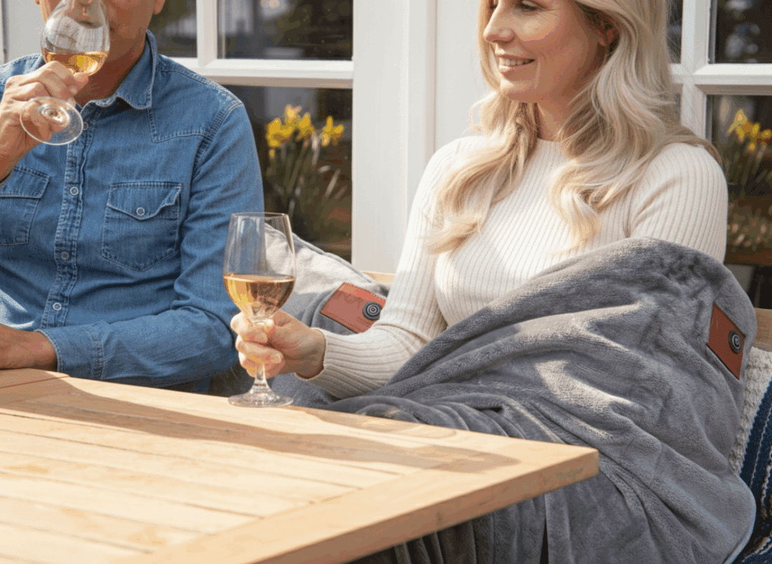Woman uses grey infrared heat blanket on terrace