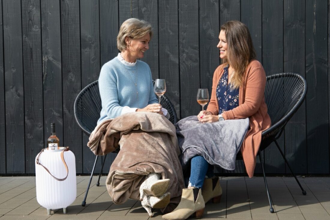 ladies drink rose in the garden in spring and have a fine infrared heat blanket over them ladies drink rose in the garden in spring and have a fine infrared heat blanket over them