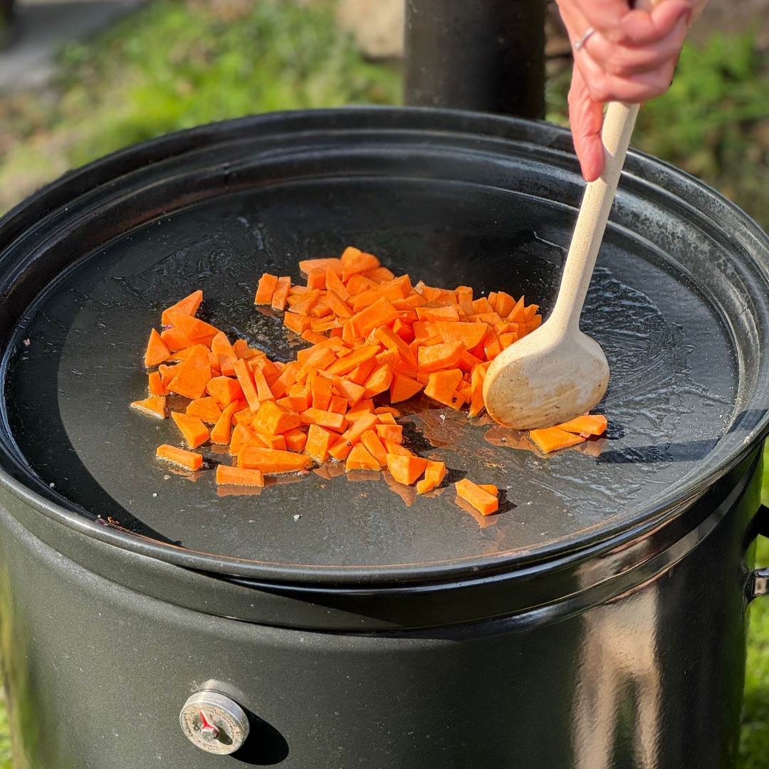 roeren met houten pollepel zoete aardappel op VUUR LAB. Bakplaat